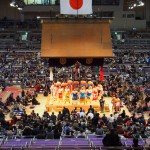 Sumo! Consecrated earth, holy tiled roof, sacred national flag and lots of sweaty men